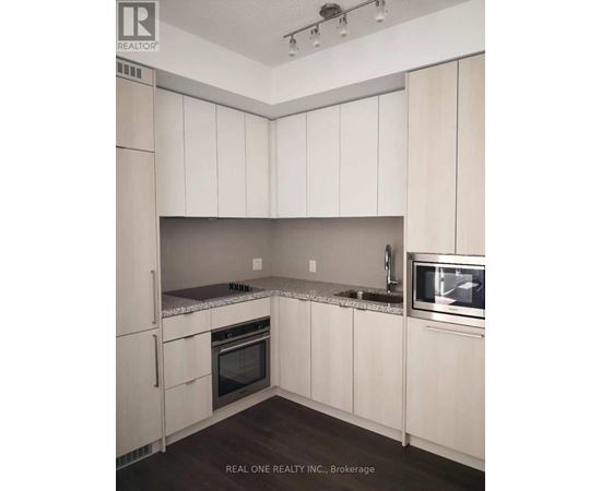 A kitchen with white cabinets and appliances.