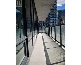 A long bridge with a metal railing and glass windows.