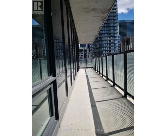 A long bridge with a metal railing and glass windows.