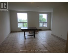 A large empty room with a table and chairs in it.