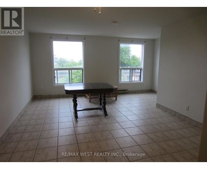 A large empty room with a table and chairs in it.