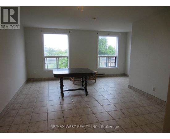 A large empty room with a table and chairs in it.