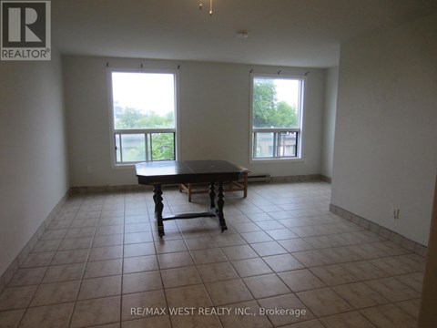 A large empty room with a table and chairs in it.