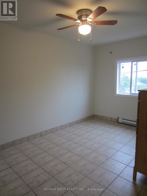A room with a ceiling fan and a window.