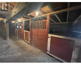 A large, empty room with wooden walls and a concrete floor.