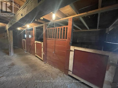 A large, empty room with wooden walls and a concrete floor.