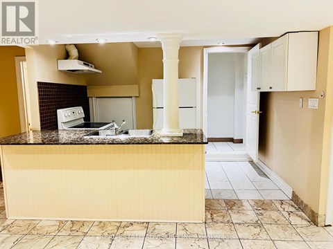A kitchen with a counter top and a fridge.
