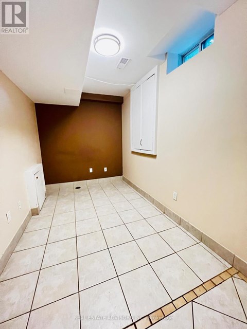 A room with brown walls and white tile flooring.