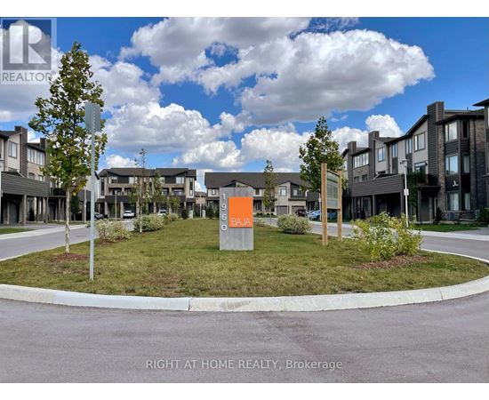A real estate sign in front of a housing development.