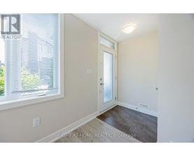 A room with a door and a window with blinds.