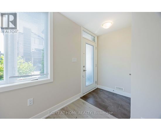 A room with a door and a window with blinds.