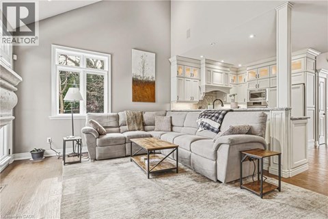 A well-lit, spacious living room with a grey sofa and a coffee table.