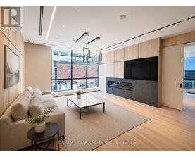 A modern living room with a flat screen TV and a fireplace.