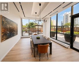 A modern dining room with a large table and chairs.