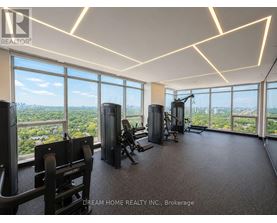 A gym with a view of the cityscape outside the large windows.