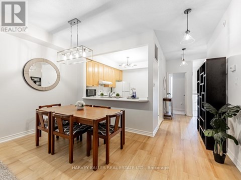 A dining room with a wooden table and chairs.