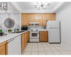 A kitchen with wooden cabinets and white appliances.