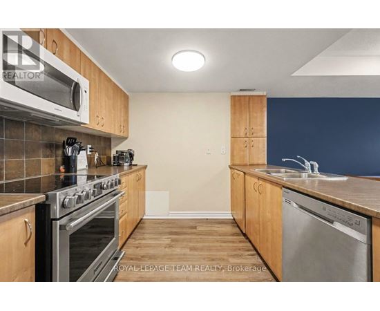 A kitchen with wooden cabinets and stainless steel appliances.