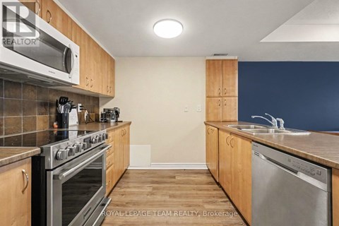 A kitchen with wooden cabinets and stainless steel appliances.