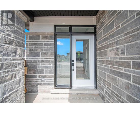 A door with a glass window is set in a stone wall.