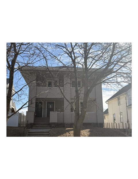 A house with a tree in front of it.
