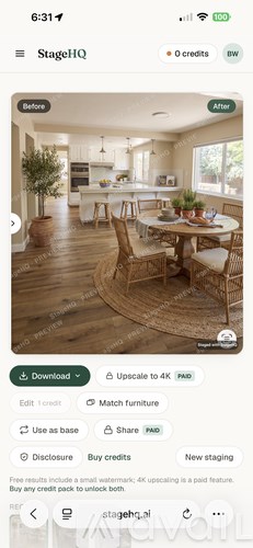 A dining room with a round table and chairs.