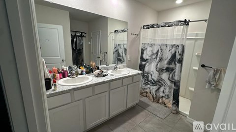 A bathroom with a marble shower curtain and a white vanity.