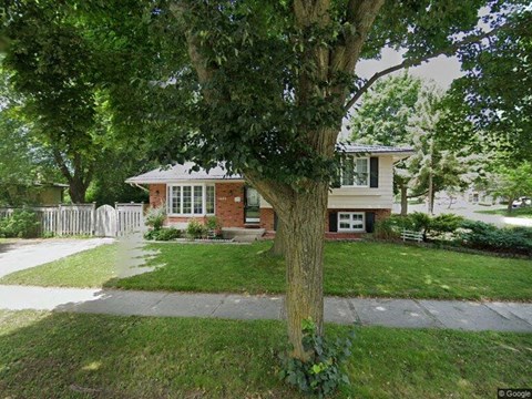A tree in front of a house.