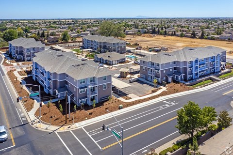A large apartment complex with multiple buildings and a parking lot.