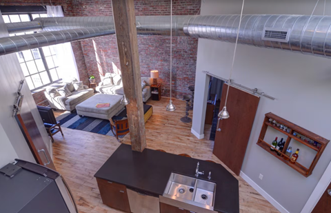 A kitchen with a sink and a refrigerator.