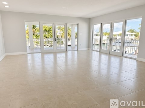 A spacious room with large windows and sliding doors.