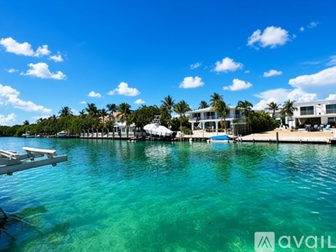 A serene waterfront scene with a dock and buildings in the distance.