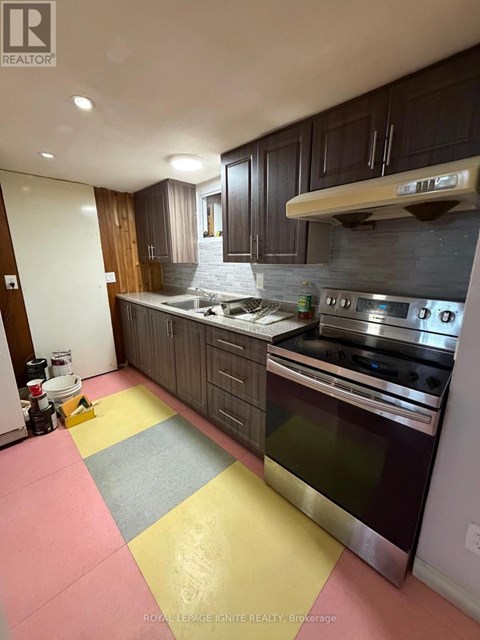 A kitchen with a stove top oven and a counter top.