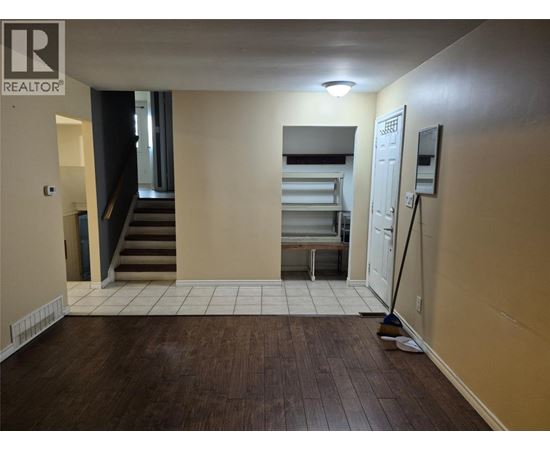 A room with a brown floor and a white door.