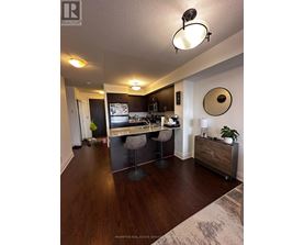 A kitchen with a bar stool and a counter.