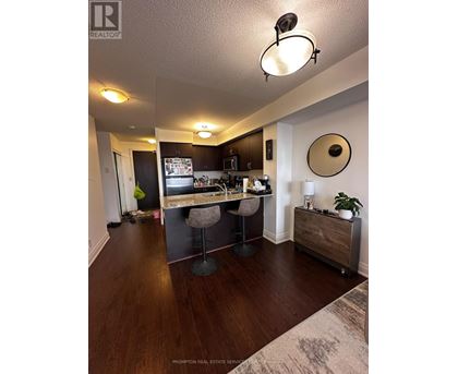 A kitchen with a bar stool and a counter.