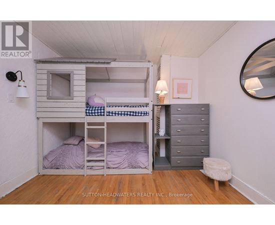 A bedroom with a bunk bed and a dresser.