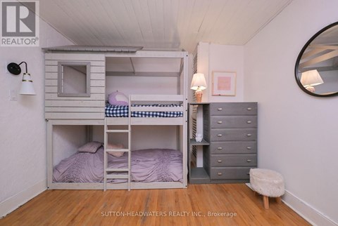 A bedroom with a bunk bed and a dresser.