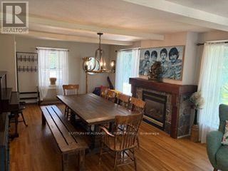 A dining room with a wooden table and chairs.