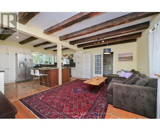 A living room with a rug and a couch.