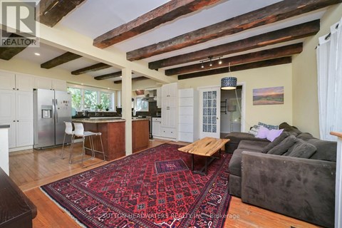 A living room with a rug and a couch.