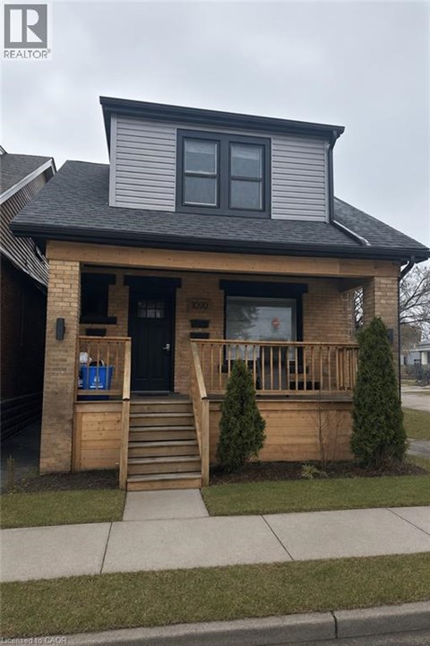 A house with a black front door and a small porch.