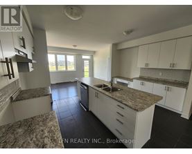 A kitchen with granite countertops and white cabinets.