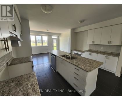 A kitchen with granite countertops and white cabinets.