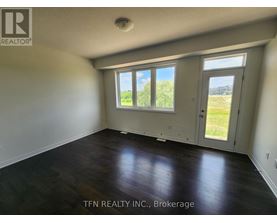 A room with a sliding glass door leading to a grassy area.