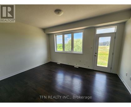 A room with a sliding glass door leading to a grassy area.