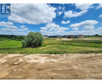 A real estate brokerage logo is superimposed on a photo of a construction site.