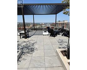 A rooftop patio with a table and chairs.