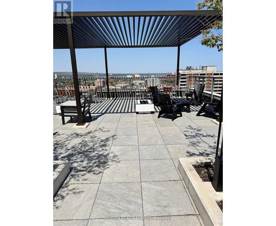 A rooftop patio with a table and chairs.