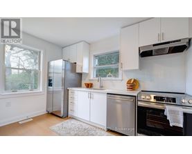 A kitchen with white cabinets and stainless steel appliances.